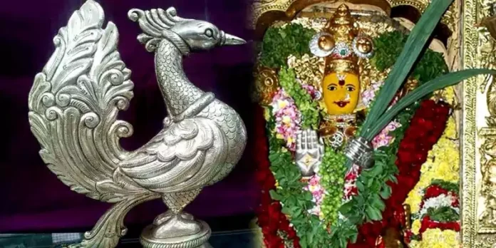 Offering silver peacock to Goddess Durga
