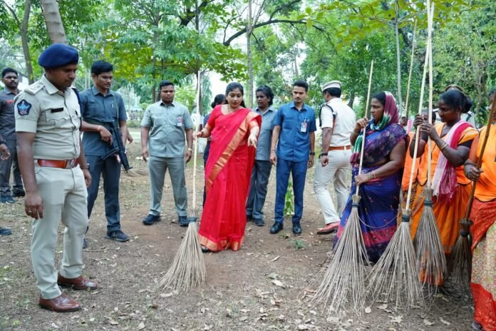 Minister Anitha sweeps the garbage with a broom