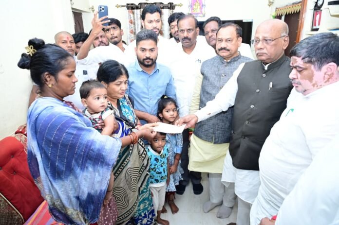 Mahesh Kumar Goud presents Rs 5 lakh ex-gratia cheque to Eshwarachari's family.